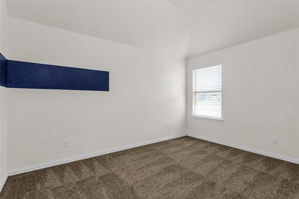 15713 Canyon Ridge Prosper, TX 75078 - Photo 31 of 38 Bright interior room featuring white walls, a single window with horizontal blinds, and patterned brown carpet flooring