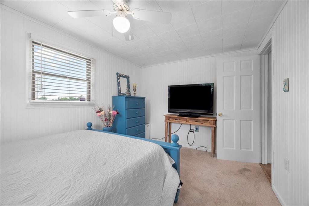 2033 McKees Rocks Road McKees Rocks, PA 15136 - Photo 17 of 33 a bedroom with a bed and a flat screen tv