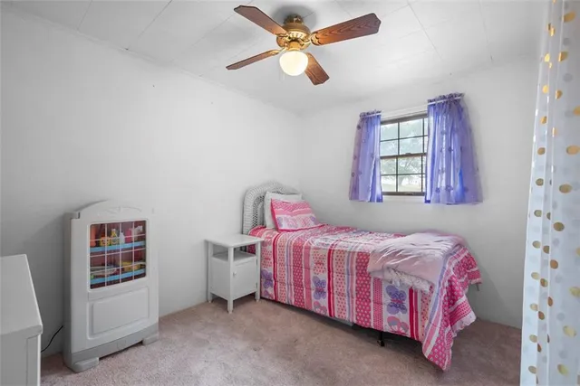 a bedroom with a bed closet and window