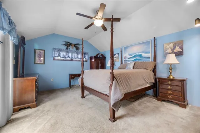 a spacious bedroom with a bed and a chandelier