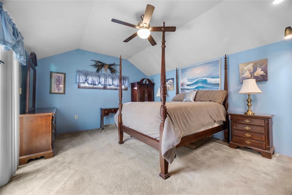 2033 McKees Rocks Road McKees Rocks, PA 15136 - Photo 20 of 33 a spacious bedroom with a bed and a chandelier