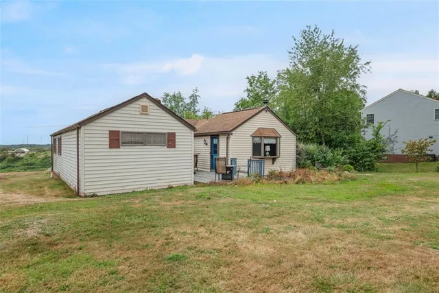 a house with a yard and wooden fence