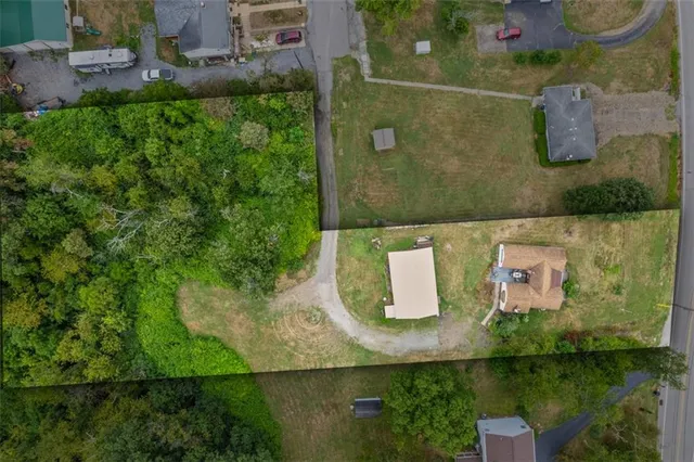 an aerial view of a residential houses with outdoor space