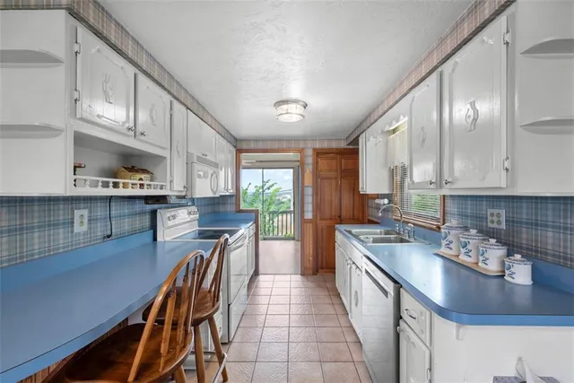 a kitchen with kitchen island granite countertop lots of counter top space and stainless steel appliances