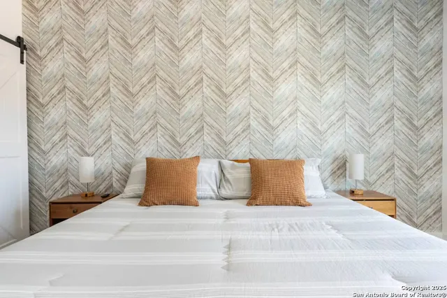 a bedroom with a bed and a lamp on roof