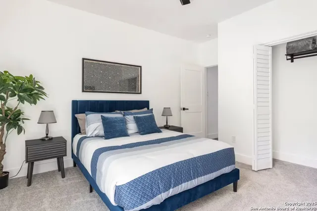 a bedroom with bed and a potted plant