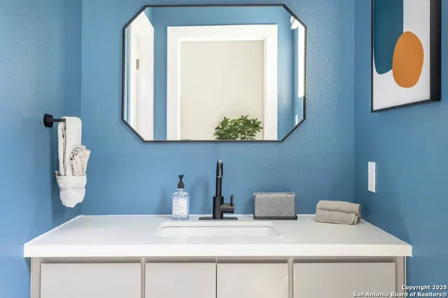 a bathroom with a sink and a mirror