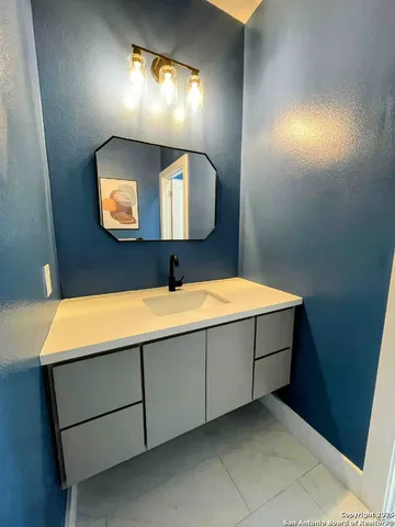 a bathroom with a sink and a mirror