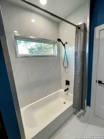 a bathroom with a bath tub and a shower