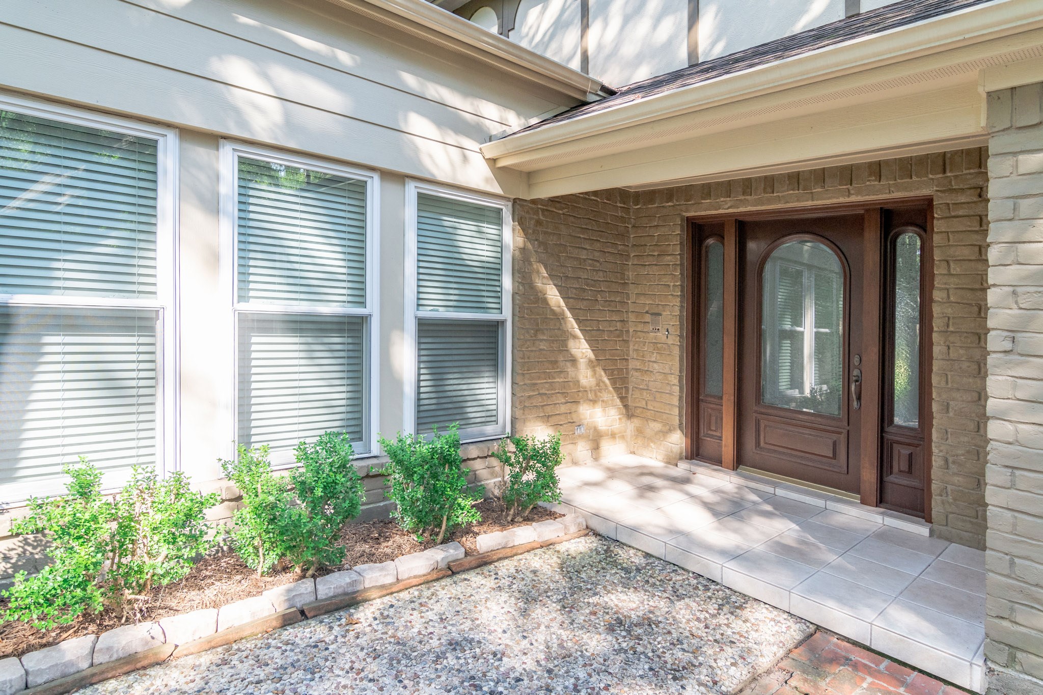 10 Coralvine Court Spring, TX 77380 - Photo 6 of 34 Rock lined landscaped beds with fresh greenery adds color. Stained arched wood front door makes a standout statement.
