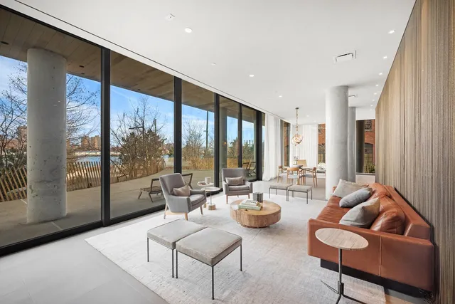 a living room with furniture and large windows