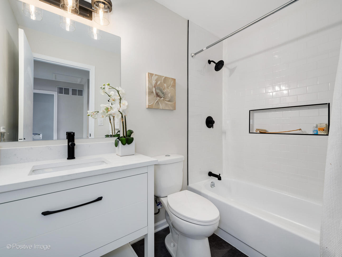 1475 Foxcroft Drive Aurora, IL 60506 - Photo 18 of 23 a bathroom with a sink a toilet a mirror a vanity a bathtub and shower