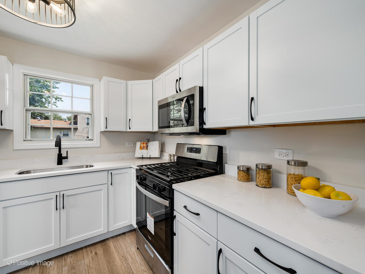 1475 Foxcroft Drive Aurora, IL 60506 - Photo 9 of 23 a kitchen with a sink a stove and cabinets