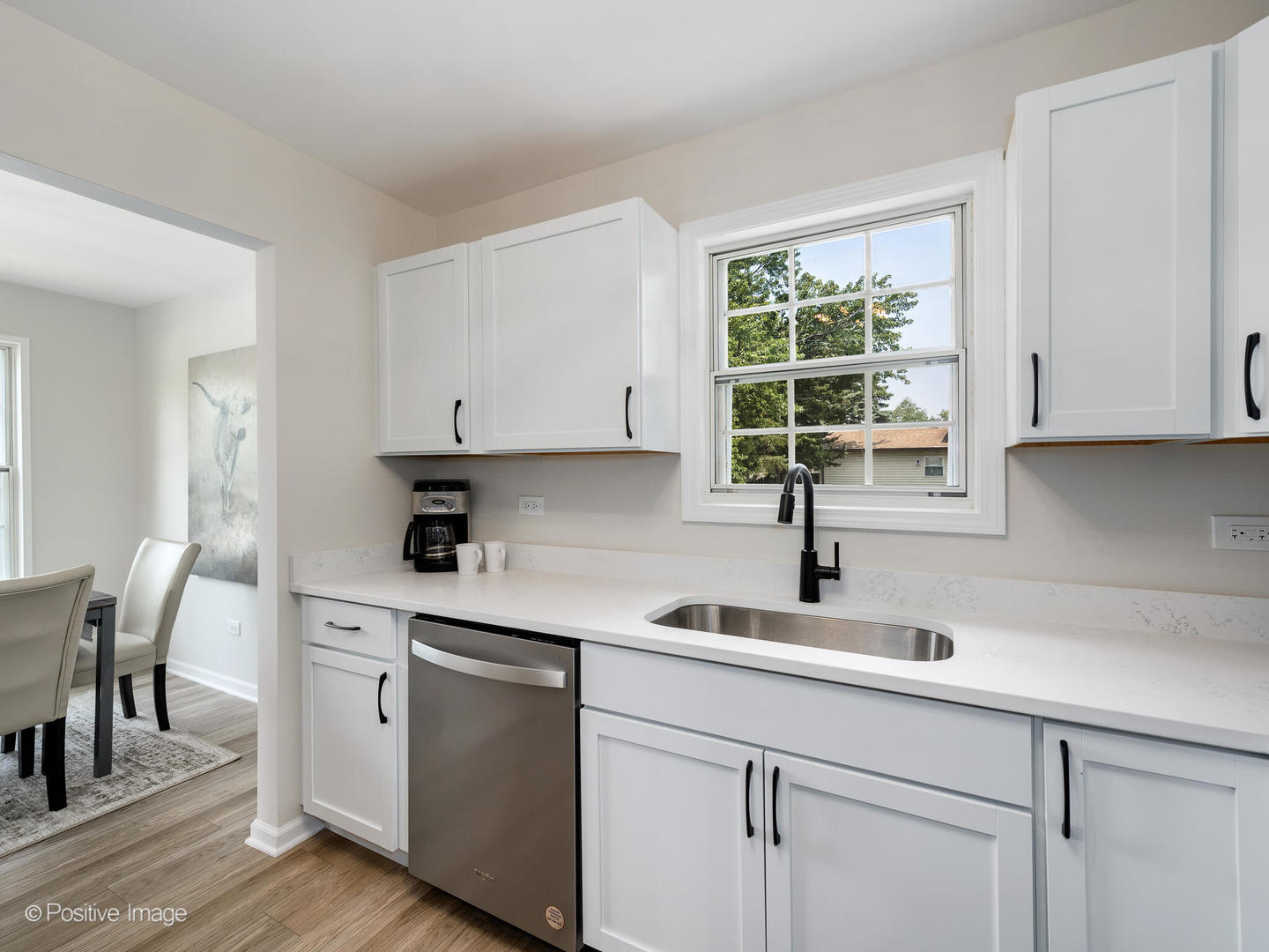 1475 Foxcroft Drive Aurora, IL 60506 - Photo 10 of 23 a kitchen with stainless steel appliances white cabinets a window and a sink