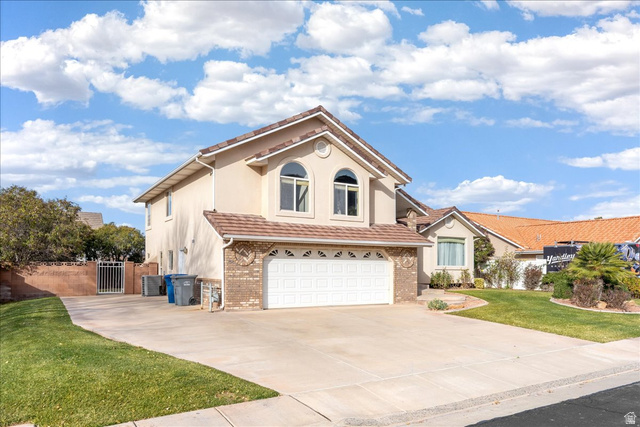 7 Reflection Way St. George, UT 84770 - Photo 1 of 54 View of front of property with an attached garage, concrete driveway, a gate, stucco siding, and brick siding