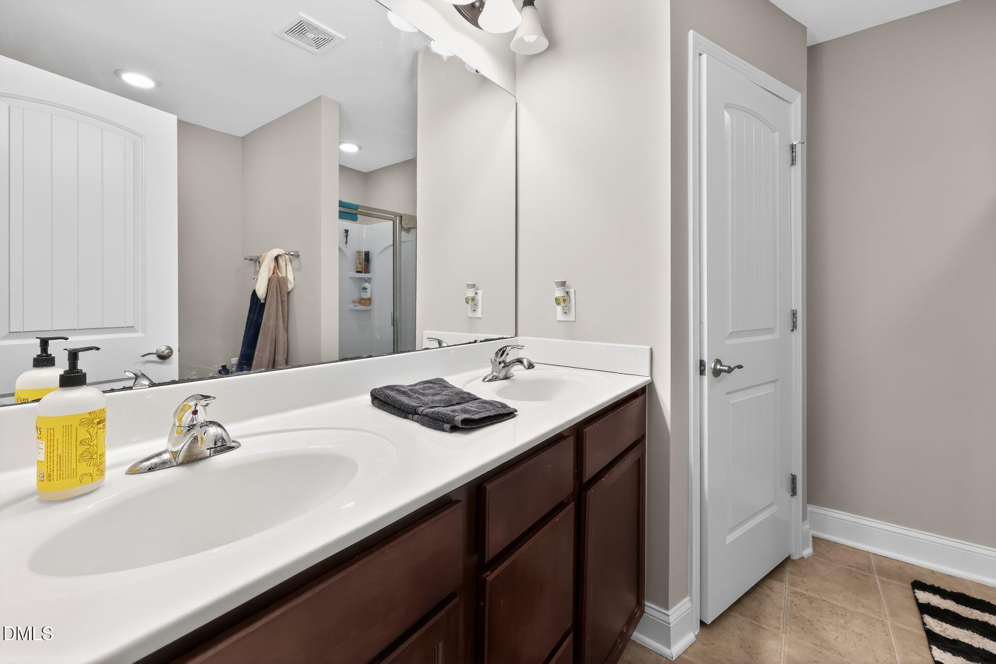 5721 Princess Curry Way Raleigh, NC 27610 - Photo 19 of 29 a bathroom with a sink and a mirror
