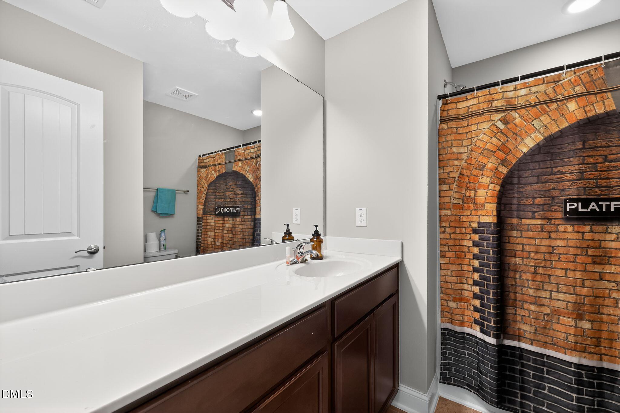 5721 Princess Curry Way Raleigh, NC 27610 - Photo 24 of 29 a bathroom with a sink and a mirror