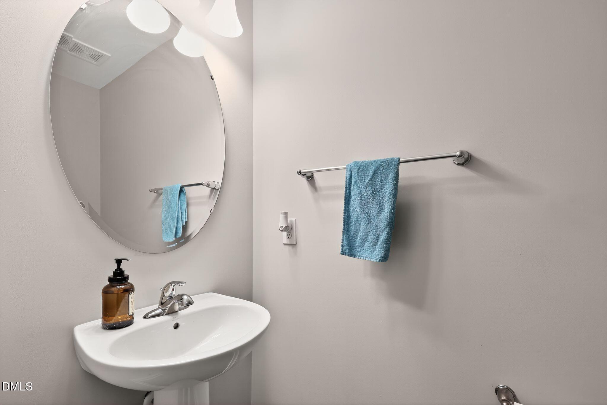 5721 Princess Curry Way Raleigh, NC 27610 - Photo 25 of 29 a bathroom with a sink and mirror