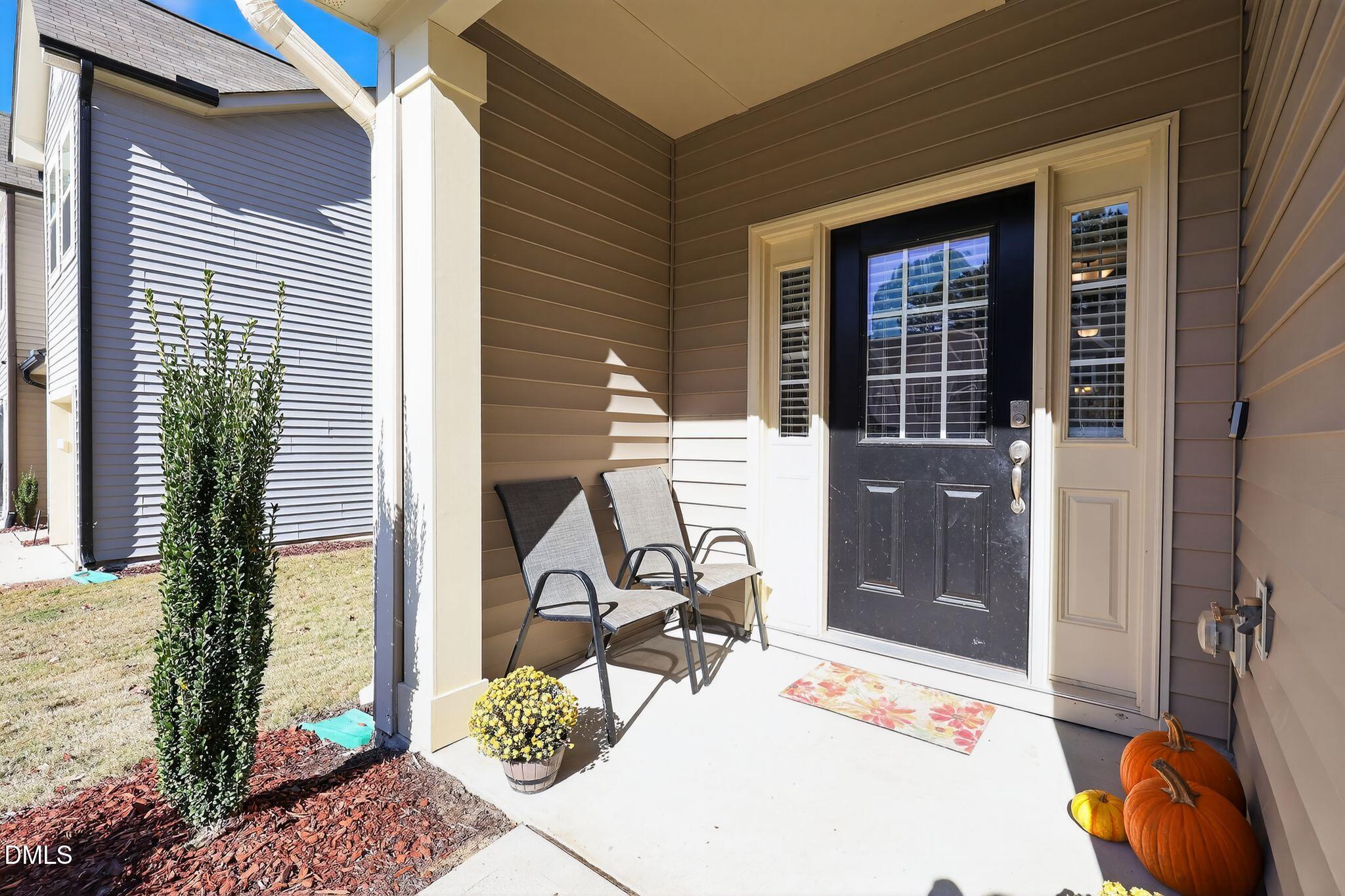 5721 Princess Curry Way Raleigh, NC 27610 - Photo 5 of 29 a balcony with table and chairs