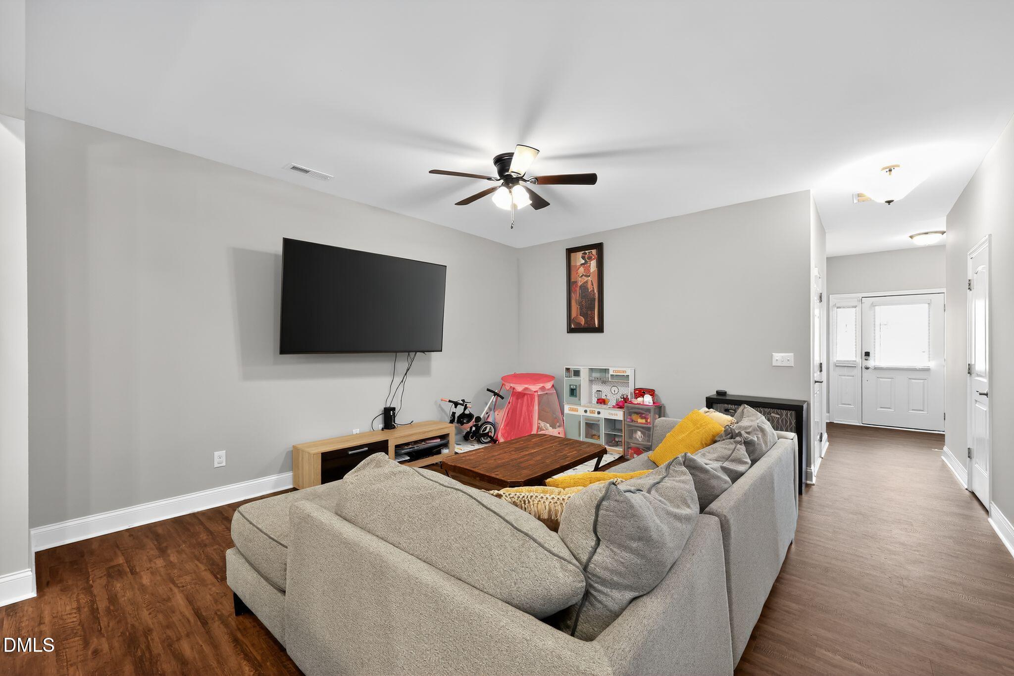 5721 Princess Curry Way Raleigh, NC 27610 - Photo 7 of 29 a bedroom with bed and a flat screen tv