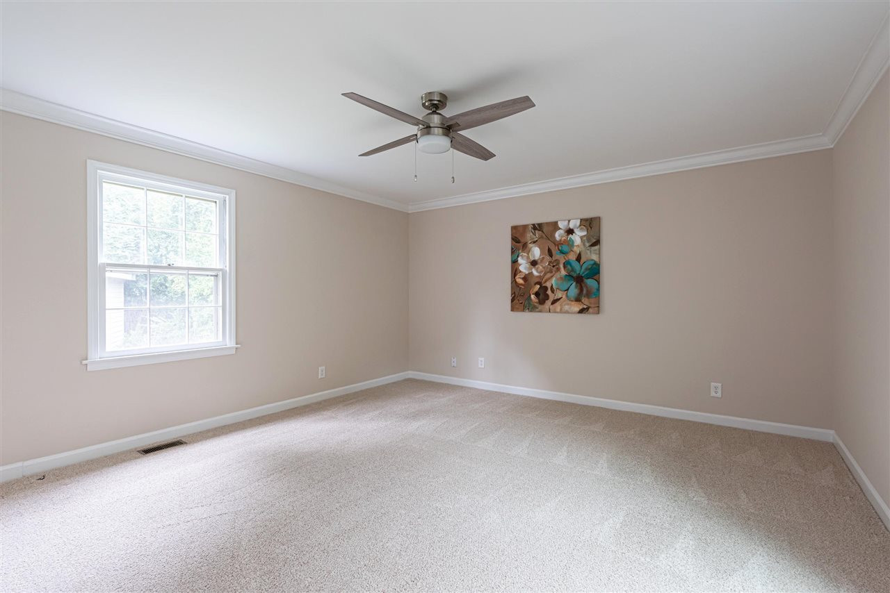 1701 Pony Run Road Raleigh, NC 27615 - Photo 11 of 30 First Floor Master Bedroom with crown molding, HUGE walk-in closet w/ shoe station- ceiling fan. Master Bedroom