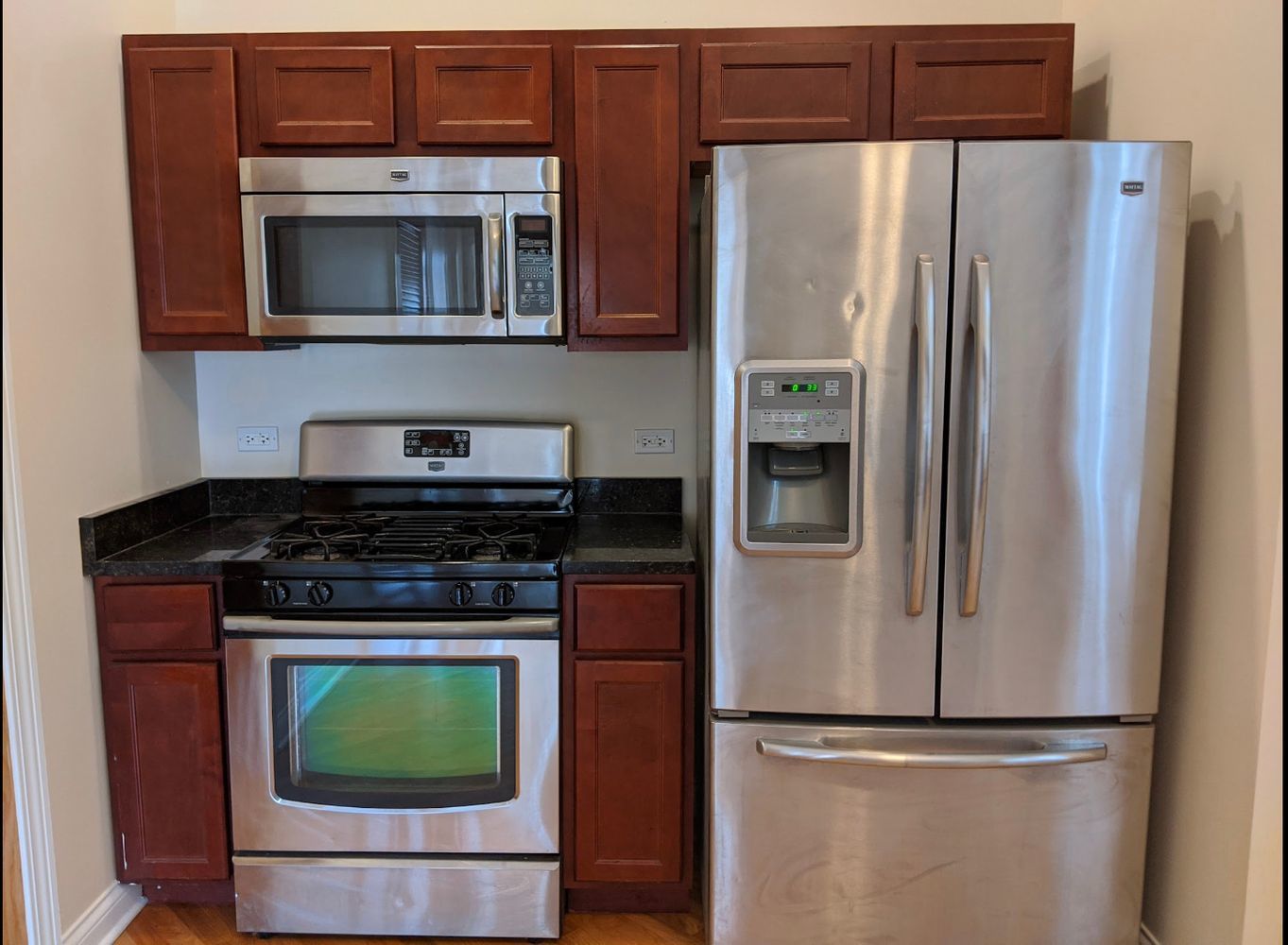 1100 West Taylor Street, Unit 3F Chicago, IL 60607 - Photo 2 of 9 a kitchen with stainless steel appliances granite countertop a refrigerator and a stove top oven