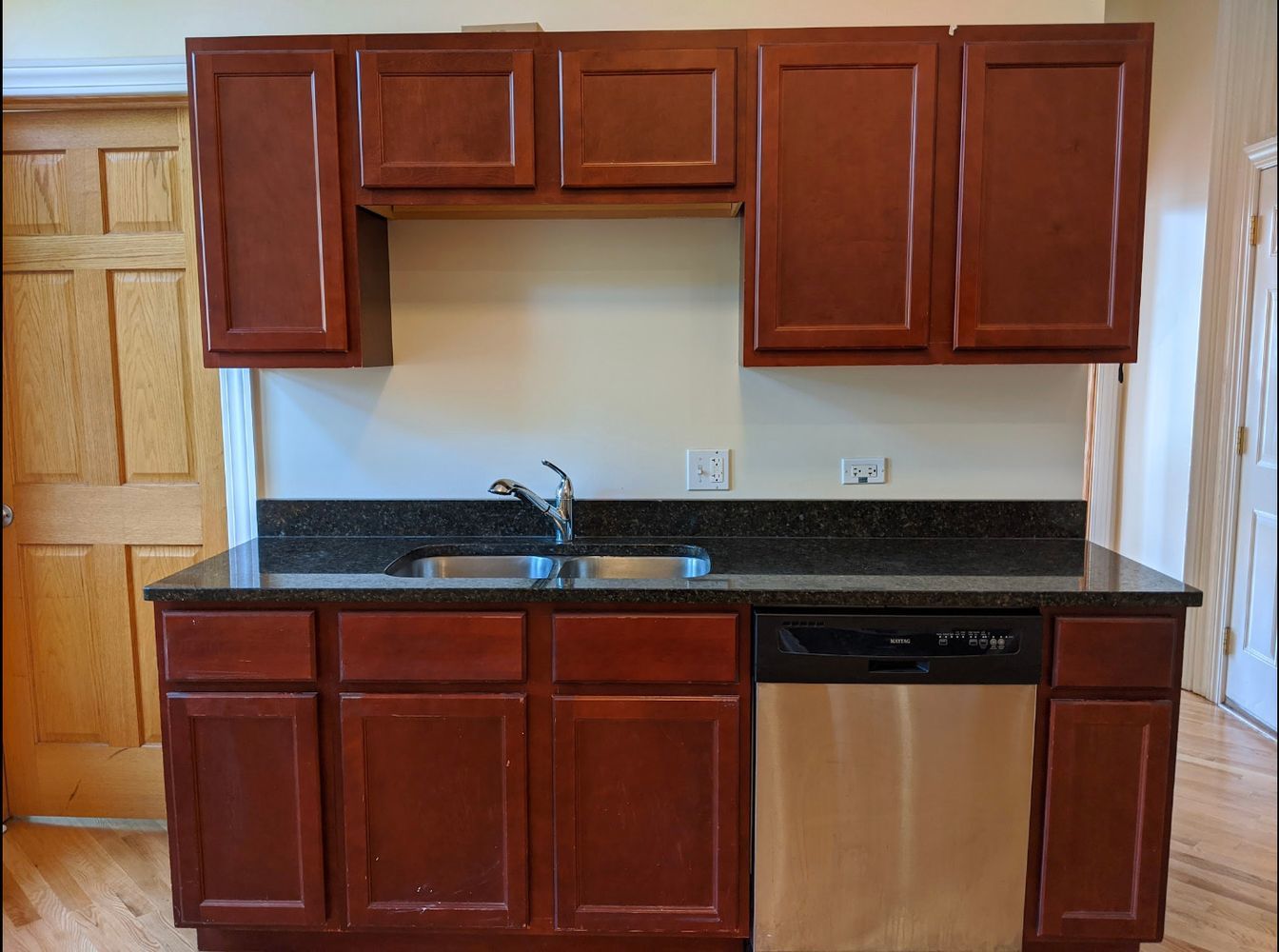 1100 West Taylor Street, Unit 3F Chicago, IL 60607 - Photo 3 of 9 a kitchen with granite countertop wood cabinets stainless steel appliances and a sink