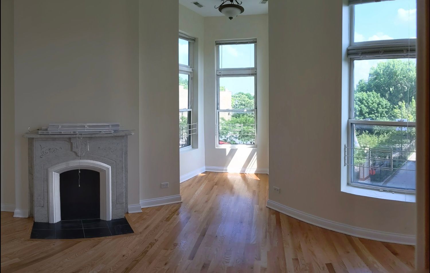 1100 West Taylor Street, Unit 3F Chicago, IL 60607 - Photo 6 of 9 a view of an empty room with wooden floor and a window