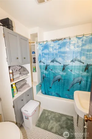 a bathroom with a toilet and a shower