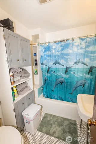 a bathroom with a toilet and a shower