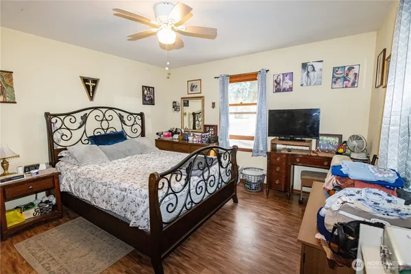 a bedroom with a bed and a flat screen tv