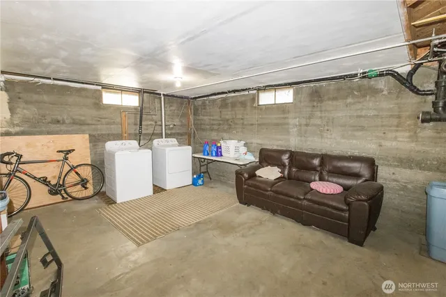 a living room with furniture and a ceiling fan
