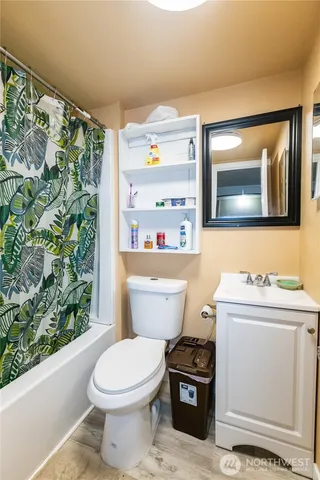 a bathroom with a toilet a sink and a mirror