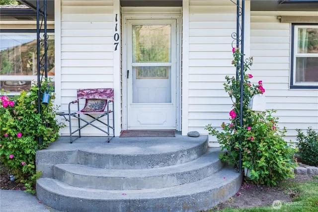 a view of a entryway door of the house with a potted plant