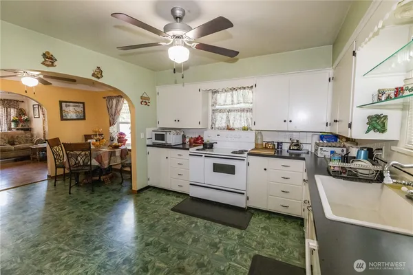 a kitchen with cabinets a window and stainless steel appliances