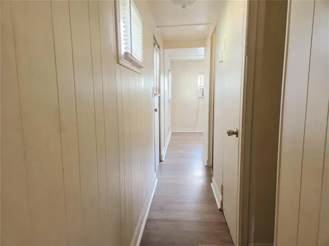 a view of a hallway with wooden floor