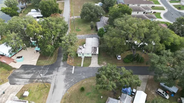 an aerial view of a house with a yard and garden