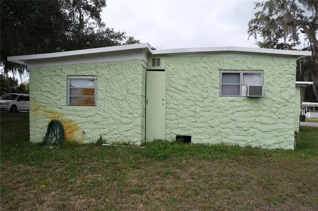 a view of a brick house with a yard