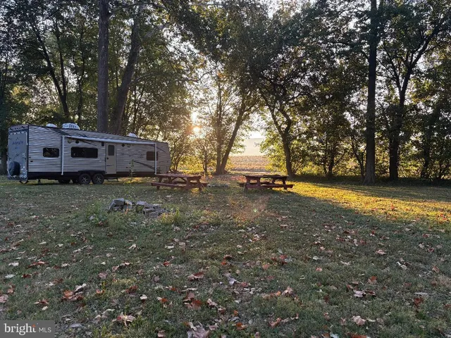 a view of a house with yard and sitting area