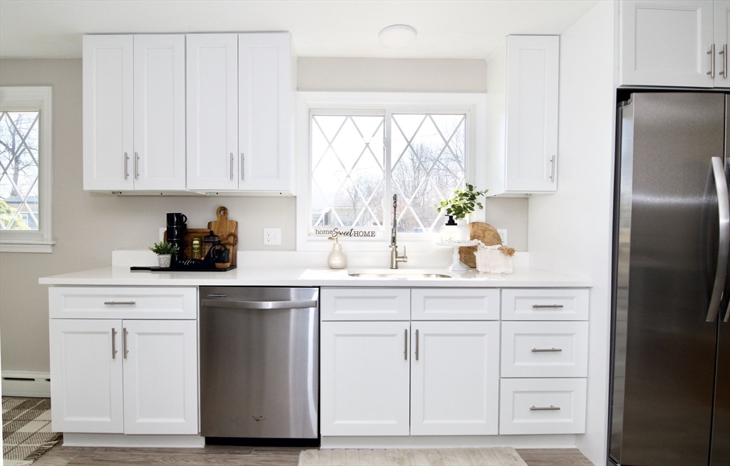 132 Lincoln Street West Springfield, MA 01089 - Photo 13 of 42 a kitchen with white cabinets and a refrigerator