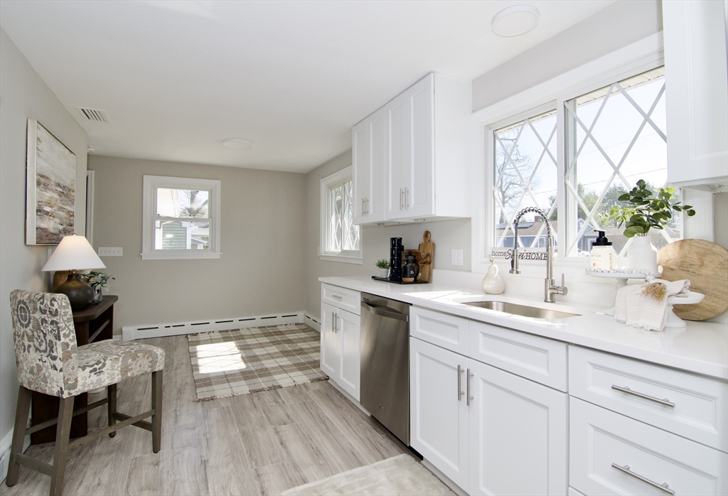 132 Lincoln Street West Springfield, MA 01089 - Photo 14 of 42 a kitchen with a white table chairs and a window
