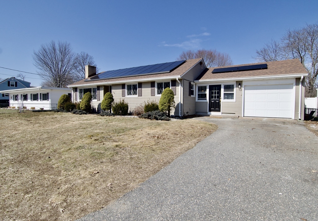 132 Lincoln Street West Springfield, MA 01089 - Photo 2 of 42 a front view of a house with a garden and trees