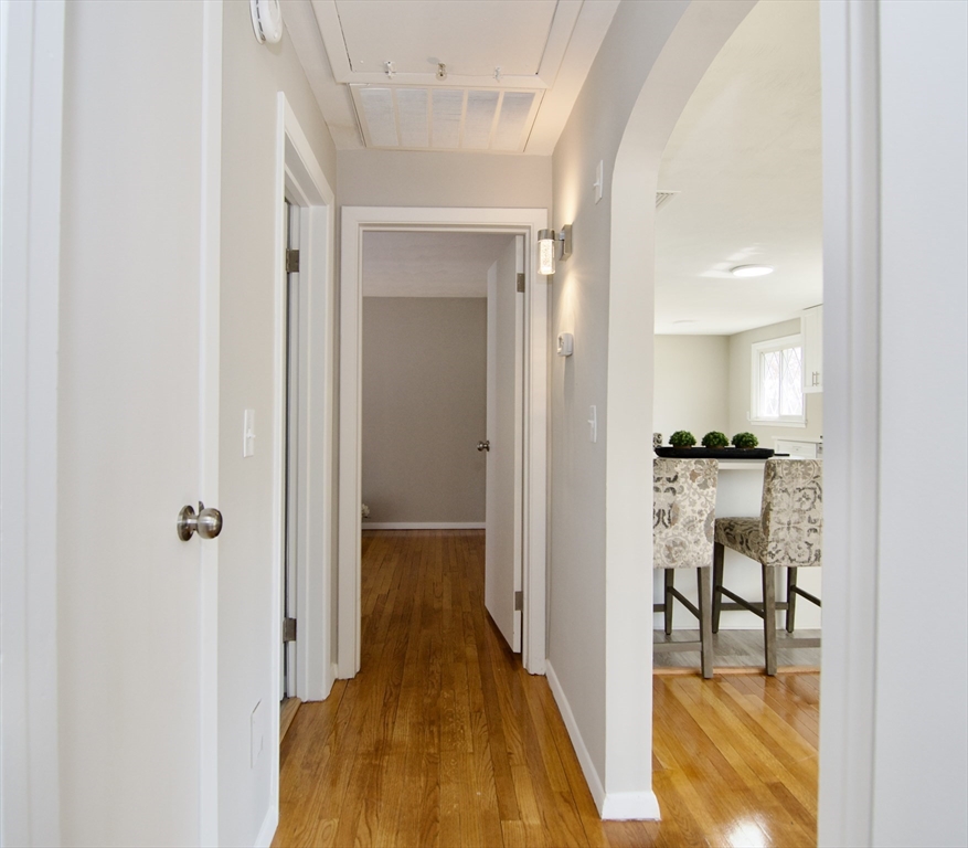 132 Lincoln Street West Springfield, MA 01089 - Photo 21 of 42 a view of a hallway with wooden floor and a living room