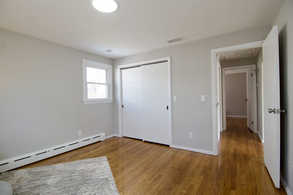 132 Lincoln Street West Springfield, MA 01089 - Photo 22 of 42 wooden floor in an empty room with a window