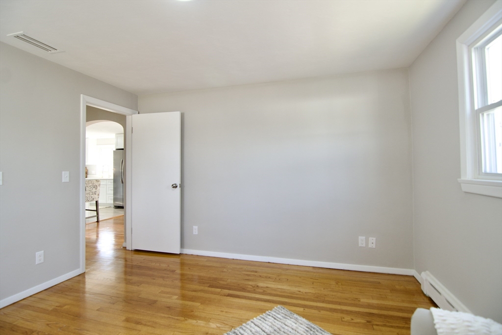 132 Lincoln Street West Springfield, MA 01089 - Photo 23 of 42 a view of an empty room with window and wooden floor