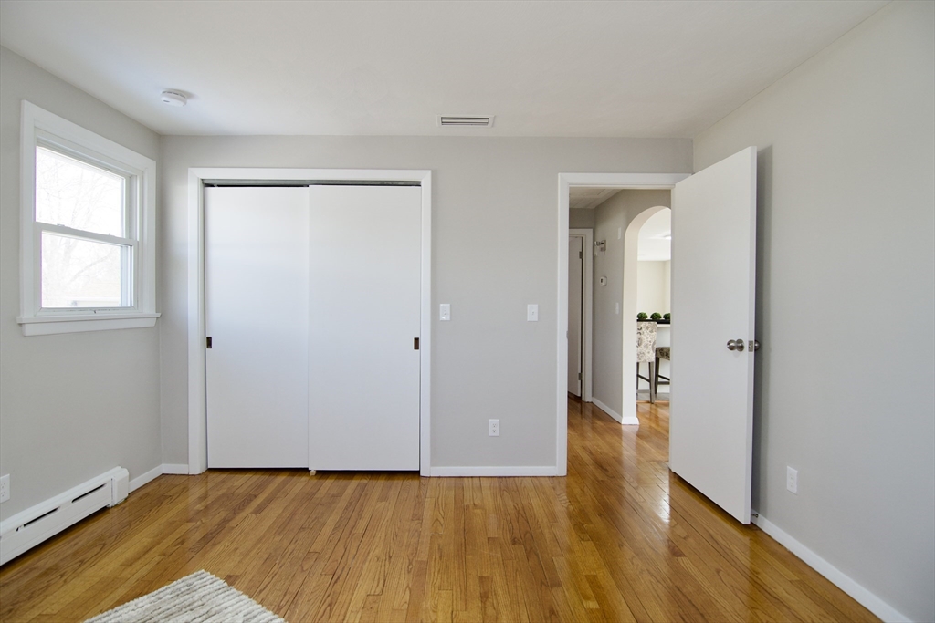 132 Lincoln Street West Springfield, MA 01089 - Photo 25 of 42 a view of an empty room with wooden floor and a window