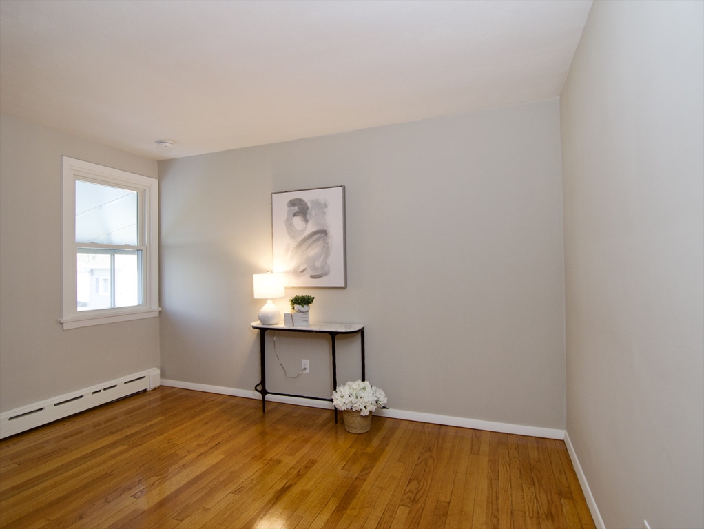 132 Lincoln Street West Springfield, MA 01089 - Photo 27 of 42 a view of an empty room with wooden floor and a window