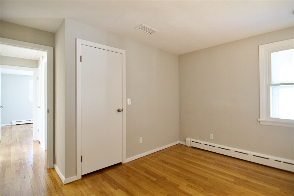 132 Lincoln Street West Springfield, MA 01089 - Photo 29 of 42 a view of an empty room with wooden floor and a window