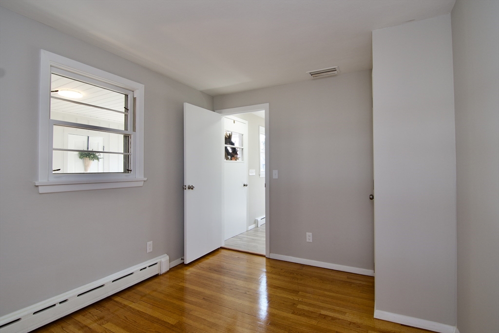 132 Lincoln Street West Springfield, MA 01089 - Photo 32 of 42 a view of an empty room with wooden floor and a window