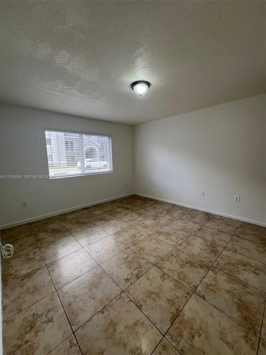 15422 Southwest 284th Street, Unit 7104 Homestead, FL 33033 - Photo 17 of 31 a view of an empty room with a window